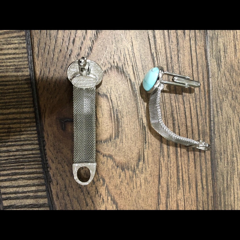 Blue and silver cuff links with chain.